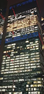 Night cityscape with illuminated skyscrapers and colorful lights.