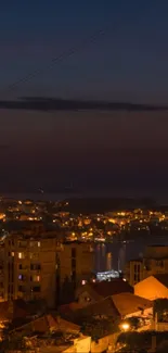 Mobile wallpaper of a cityscape at night with illuminated buildings.