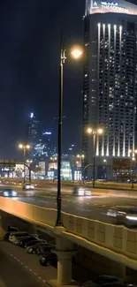 Night cityscape with bright lights and tall buildings.