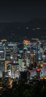 A vibrant cityscape at night with bright city lights against a dark sky.