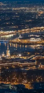 Aerial view of a city illuminated at night with sparkling lights and waterways.