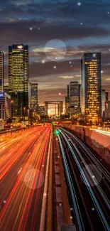 Dynamic night cityscape with lights and traffic at sunset.