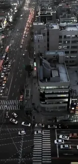 Aerial view of city traffic and buildings at night.