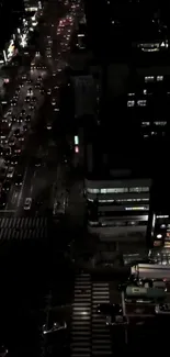 Nighttime cityscape with bustling traffic on illuminated streets.