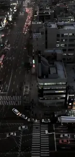 Aerial view of a bustling city at night, showcasing illuminated streets and buildings.