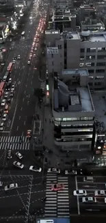 Aerial view of bustling city traffic at night with illuminated streets.