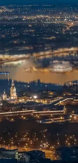 A stunning nighttime cityscape with illuminated buildings by the river.