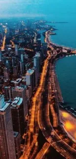 A stunning aerial view of a cityscape at night with glowing streetlights along the coastline.