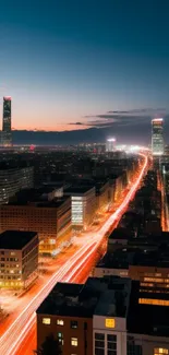 Nighttime cityscape with light trails and skyscrapers.