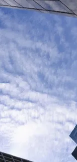 Tall skyscrapers against a blue sky with clouds.