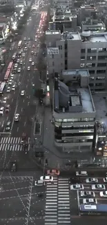 Evening cityscape with buildings and streets, captured from above in gray tones.