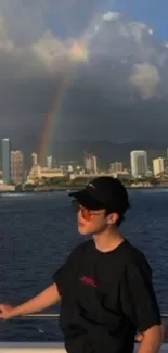 City skyline at ocean with rainbow.