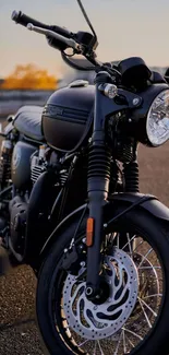 Classic black motorcycle with chrome accents in an urban setting.