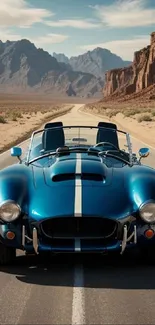 Classic blue car on a desert road with mountain backdrop.