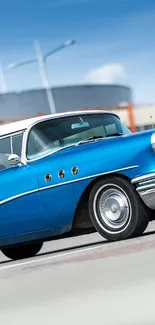 Vintage blue car parked in an urban area under a sunny sky.