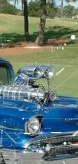 Classic blue car with chrome details on open field.