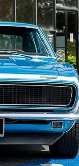 Front view of a classic blue muscle car with a shiny exterior.