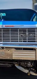 Front view of a classic blue Chevrolet car showcasing its iconic design.