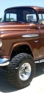 Brown vintage pickup truck parked outdoors in sunny setting.