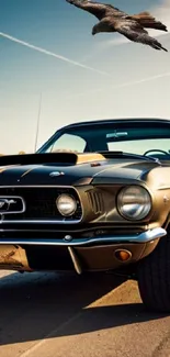 Classic yellow Mustang on road under sky with bird soaring.