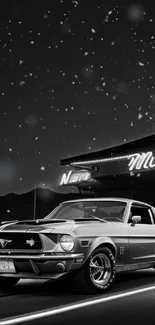 Black and white classic car under starry night sky.