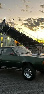 Vintage car at sunset against race track background.