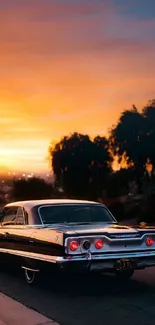 Classic car parked under a colorful sunset sky.