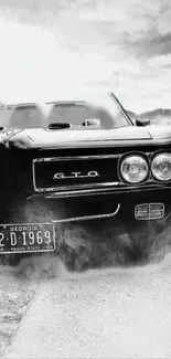 Black and white vintage car with smokey background.