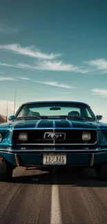 Vintage blue car on desert road under sky.