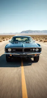 Classic car driving down a desert road under a clear blue sky.