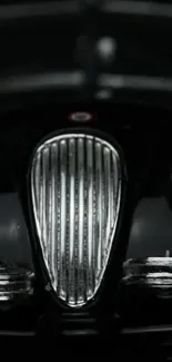 Close-up of a classic car grille with chrome detailing.