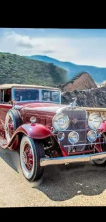 Classic car on mountain road with scenic view of nature.