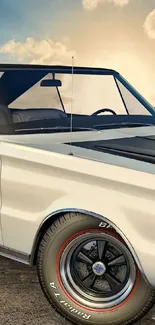 Classic car parked at sunset with scenic sky.