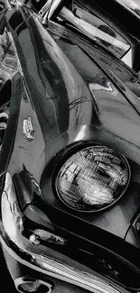 Close-up of a vintage car in black and white, showcasing classic design.