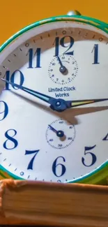 Vintage clock on books with yellow background.