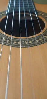 Close-up of an acoustic guitar's strings and ornate soundhole.