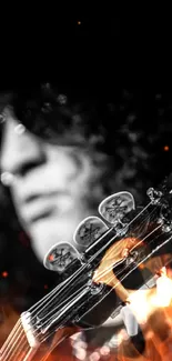 Black and white silhouette of a guitarist and guitar headstock.