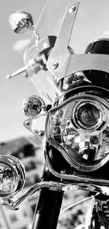 Black and white close-up of a classic motorcycle, featuring intricate details.