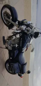 Classic motorcycle parked by the beach with a scenic coastal view.