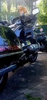 Classic motorcycle parked on a city street with trees.