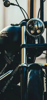 Glossy black classic motorcycle front view with chrome details.