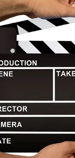 Close-up of a clapperboard in a movie setting.