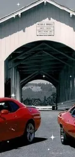 Two red classic muscle cars under a covered bridge in a scenic landscape.