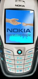 Vintage Nokia phone with 'Connecting People' slogan on screen.