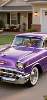 Purple classic car parked in suburban driveway.