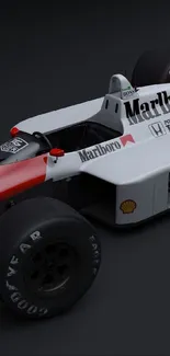 Dynamic classic Formula 1 car with iconic logos on dark background.