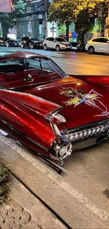 Classic red vintage Cadillac parked on a vibrant nighttime street.