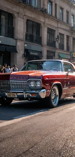 Classic red vintage car on urban street.