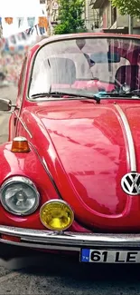 Classic red Volkswagen Beetle on urban street.