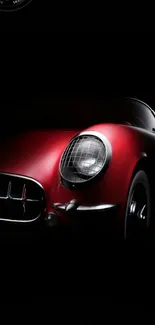 Red classic car on black background mobile wallpaper.